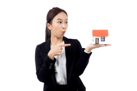 Portrait young asian businesswoman holding house for mortgage isolated white background, agent insurance business woman holding home for investment and presenting, female show home with excited.の写真素材