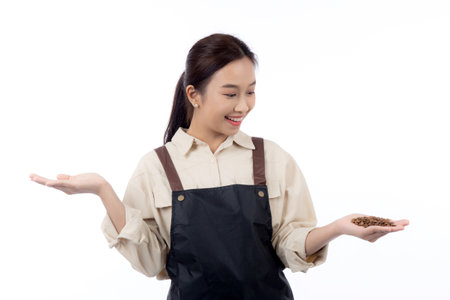 Portrait young asian barista woman wearing apron holding beans coffee isolated white background, waitress or entrepreneur cheerful, small business or startup, waiter of cafe or coffee shop.の写真素材