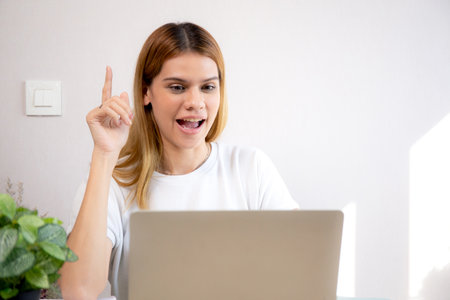 Happy young caucasian businesswoman video call for meeting in modern home office, happiness business woman conference with remote distant on desk, small business and meeting online, e-commerce.の写真素材