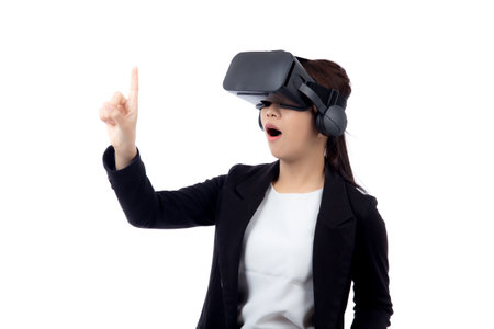 Portrait young asian businesswoman wearing headset virtual reality for device with experience and entertainment with interactive isolated white background, simulation and innovation with business.の写真素材