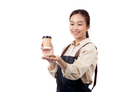 Portrait young asian barista woman wearing apron holding beans coffee and coffee cup isolated white background, waitress or entrepreneur cheerful, small business or startup, waiter of cafe.の写真素材