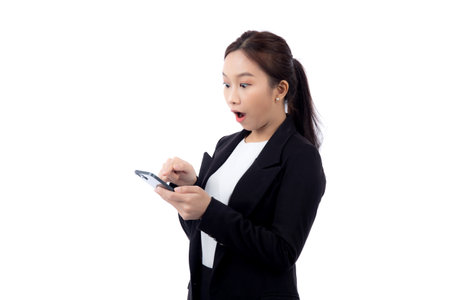Portrait young asian businesswoman in suit gesture surprised while looking smartphone isolated white background, business woman excited with amazed while looking smart phone, business concept.の写真素材