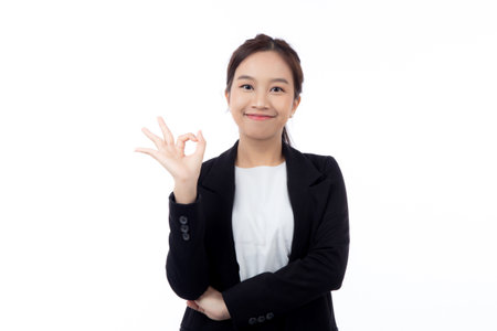 Portrait young asian business woman in suit gesture ok with confident and achievement isolated white background, businesswoman with expression with satisfaction and smile, business concept.の写真素材