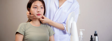 Young asian patient woman consulting with doctor in coat about wrinkle and skin for rejuvenate and beauty in modern medical office, doctor explaining and diagnostic facial of woman for cosmetology.の写真素材