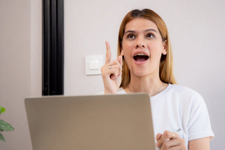 Happy young caucasian businesswoman video call for meeting in modern home office, happiness business woman conference with remote distant on desk, small business and meeting online, e-commerce.の写真素材