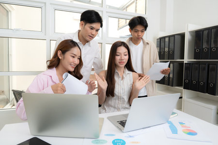 Young asian business team collaboration on project in modern office, group business people working brainstorming for planning and strategy of marketing and finance, teamwork of startup.の写真素材
