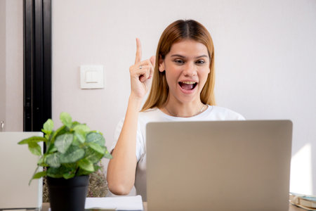 Happy young caucasian businesswoman video call for meeting in modern home office, happiness business woman conference with remote distant on desk, small business and meeting online, e-commerce.の写真素材