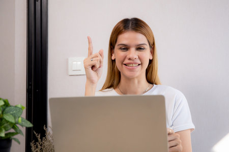 Happy young caucasian businesswoman video call for meeting in modern home office, happiness business woman conference with remote distant on desk, small business and meeting online, e-commerce.の写真素材