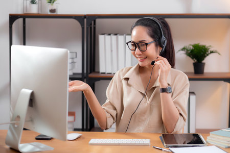 Professional young asian business woman working and meeting online in modern home office, businesswoman video call with conference distant, call center and support, consulting with business.の写真素材
