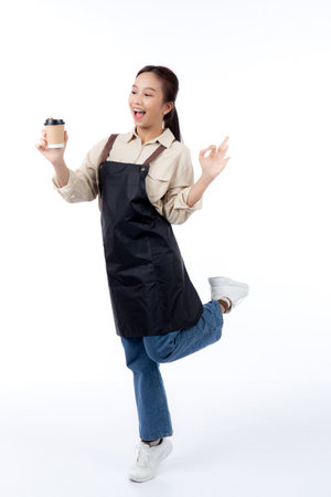 Portrait young asian woman barista holding a takeaway coffee cup with excited gesture ok isolated white background, happy barista presenting takeaway coffee with success, small business or startup.の写真素材