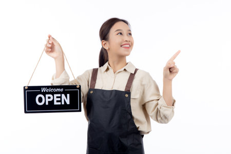 Portrait young asian barista woman wearing apron holding open sign for inviting customer to enter...