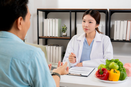 Asian nutritionist consulting patient in clinic, meal plan discussion, healthcare advice, weight loss support, doctor talking and explaining patient for nutrition consultation, wellness care.の写真素材