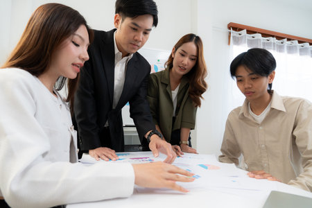 Young asian business team collaboration on project in modern office, group business people working brainstorming for planning and strategy of marketing and finance, teamwork of startup.の写真素材