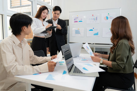 Group asian business team meeting for planning and strategy marketing in office, data analysis of financial with graph and chart while brainstorming, presenting and explaining marketing of statistic.の写真素材