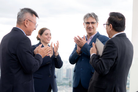 Business team group discussion on rooftop with negotiation and agreement in cityscape, teamwork and collaboration with success in urban, diversity and ethnicity, networking and marketing.の写真素材