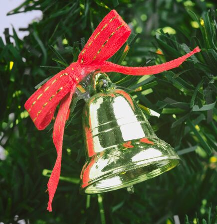 close up of a gold bell on the Christmas treeの写真素材