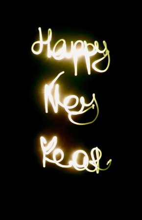 the word happy new year from the lights on a backgroundの写真素材