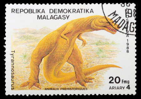 REPUBLICA MALAGASY - CIRCA 1988: A stamp printed in Malagasy (Madagascar) shows dinosaur Tyranosaurus, circa 1988の写真素材
