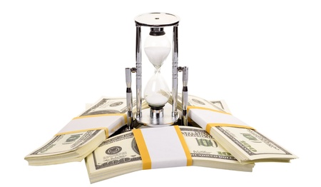 The stack of dollars with an hourglass isolated on a white background