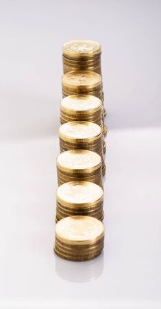 The stack of gold coins isolated on a white backgroundの写真素材