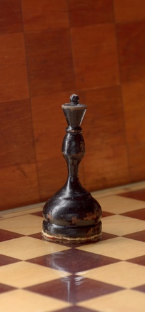 wooden chess pieces on a chessboard background
