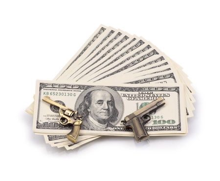 pack of dollars and weapon isolated on a white backgroundの写真素材