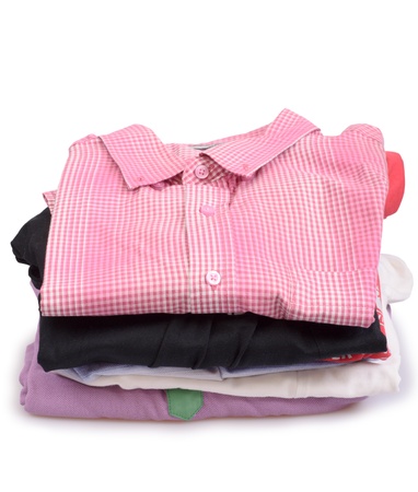 Stacks of many colored clothes isolated on a white backgroundの写真素材