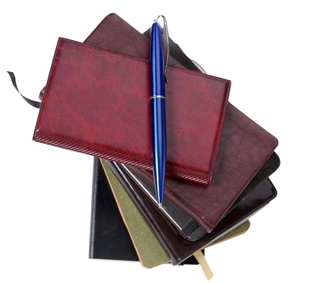 Notebooks and pen isolated on a white backgroundの写真素材