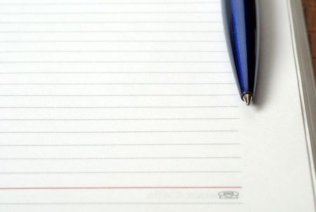 Open notebook with pen on clean sheetsの写真素材