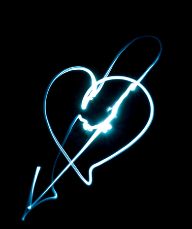 drawing heart by flashlight in the airの写真素材
