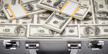 pack of dollars in an open safe close-up