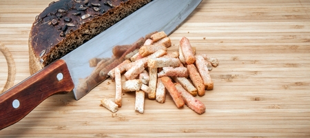 rye bread with a knife and crackers on a wooden board