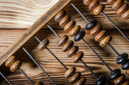 Old wooden abacus on wooden background. Close-upの写真素材