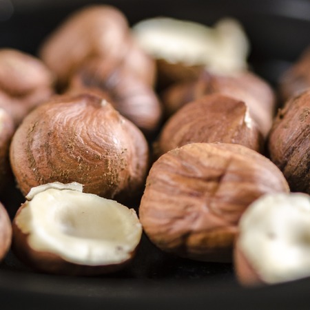 Hazelnuts nuts in bowl. Food background. Close up