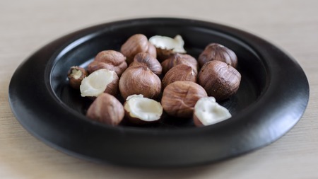 Hazelnuts nuts in bowl. Food background. Close up