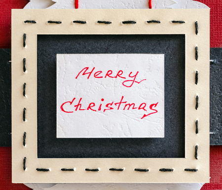 Inscription of a Merry Christmas on the buckle belt. Paper backgroundの写真素材