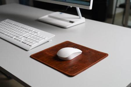 Leather Mousepad Isolated on Office Desk with White Mouseの写真素材