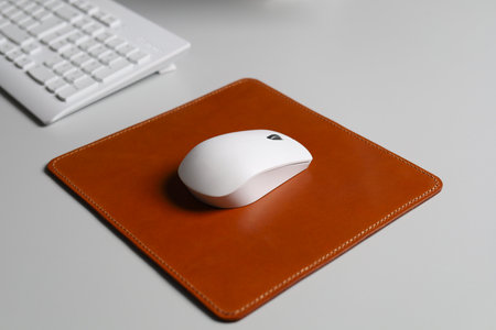Leather Mousepad Isolated on Office Desk with White Mouseの写真素材