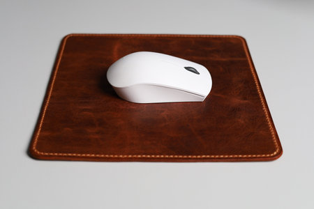 Leather Mousepad Isolated on Office Desk with White Mouseの写真素材