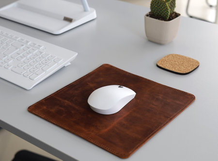 Leather Mousepad Isolated on Office Desk with White Mouseの写真素材