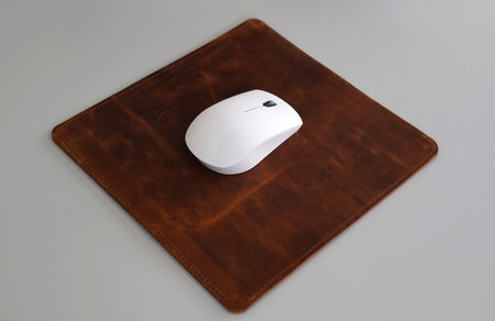 Leather Mousepad Isolated on Office Desk with White Mouseの写真素材