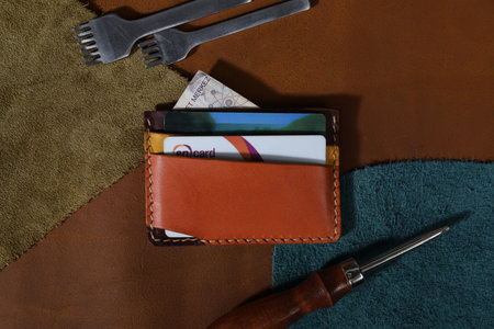 Colorful Leather Card Holder Isolated on Leathers with Leather Crafting Toolsの写真素材