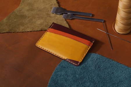 Colorful Leather Card Holder Isolated on Leathers with Leather Crafting Toolsの写真素材