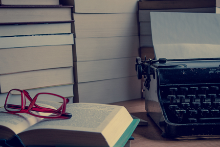 Desk with books and typewriter.の写真素材