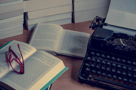 Desk with books and typewriter.の写真素材