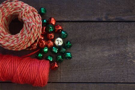 Red twine with red, green, and gold bells.の写真素材