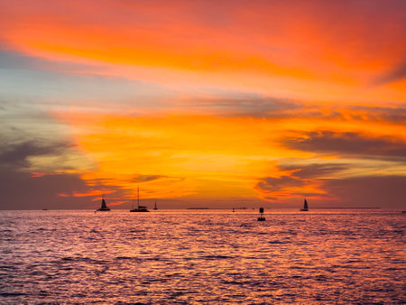 Beautiful sunset over the sea with sailboats and yachtsの写真素材