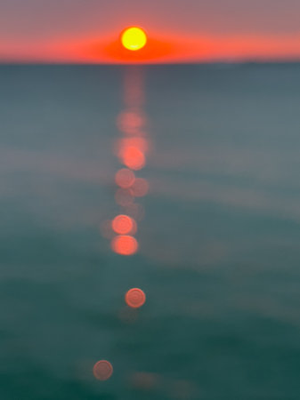 Sunset over the sea. Blurred background with bokeh.