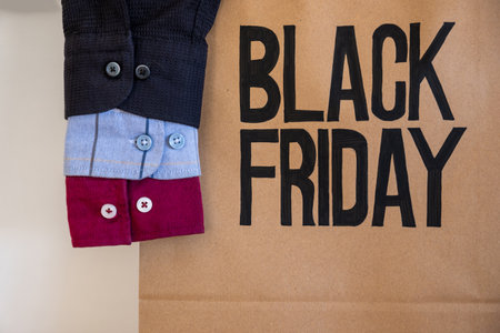Shirt sleeve with shopping bag represents clothes sales for black friday and white friday with mock...