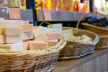 handmade basket full of handmade Flower soap in a store consist of body care products with wooden backgroundの写真素材